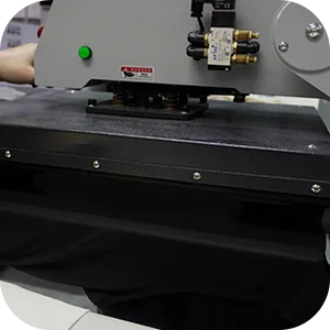 Close-up of a heat press machine preparing a garment for DTF transfer by pre-pressing.