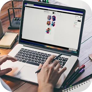 Person using our free online DTF gang sheet builder on a laptop, simplifying the design process.